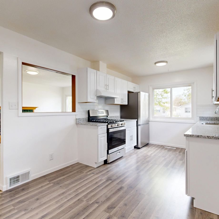 Illustrative licensed photograph: Finished remodeled residential kitchen with wood flooring