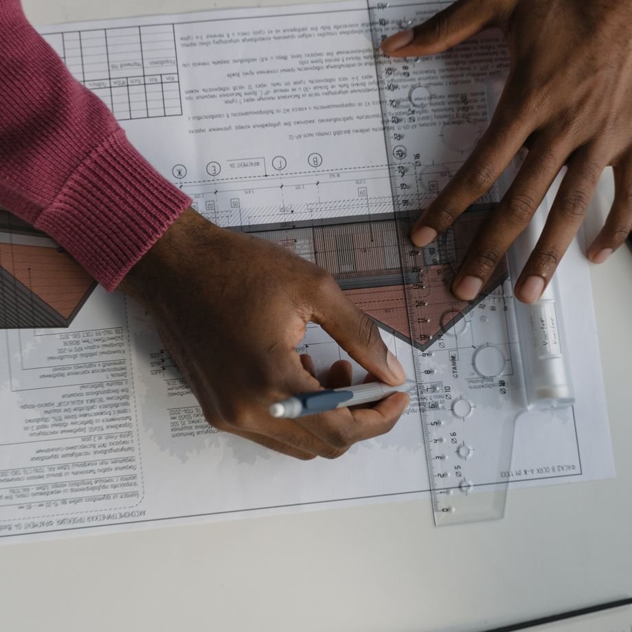 Illustrative licensed photograph: Measuring on blueprints