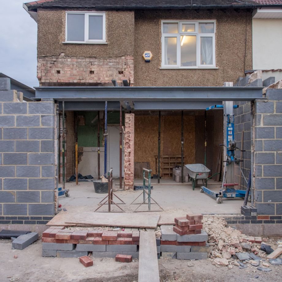 Illustrative licensed photograph: Brick house extension under construction