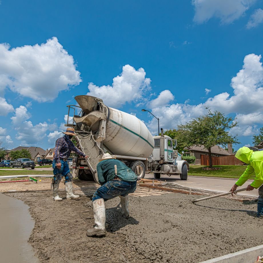 Illustrative licensed photograph: Concrete workers laying a driveway at Texas home