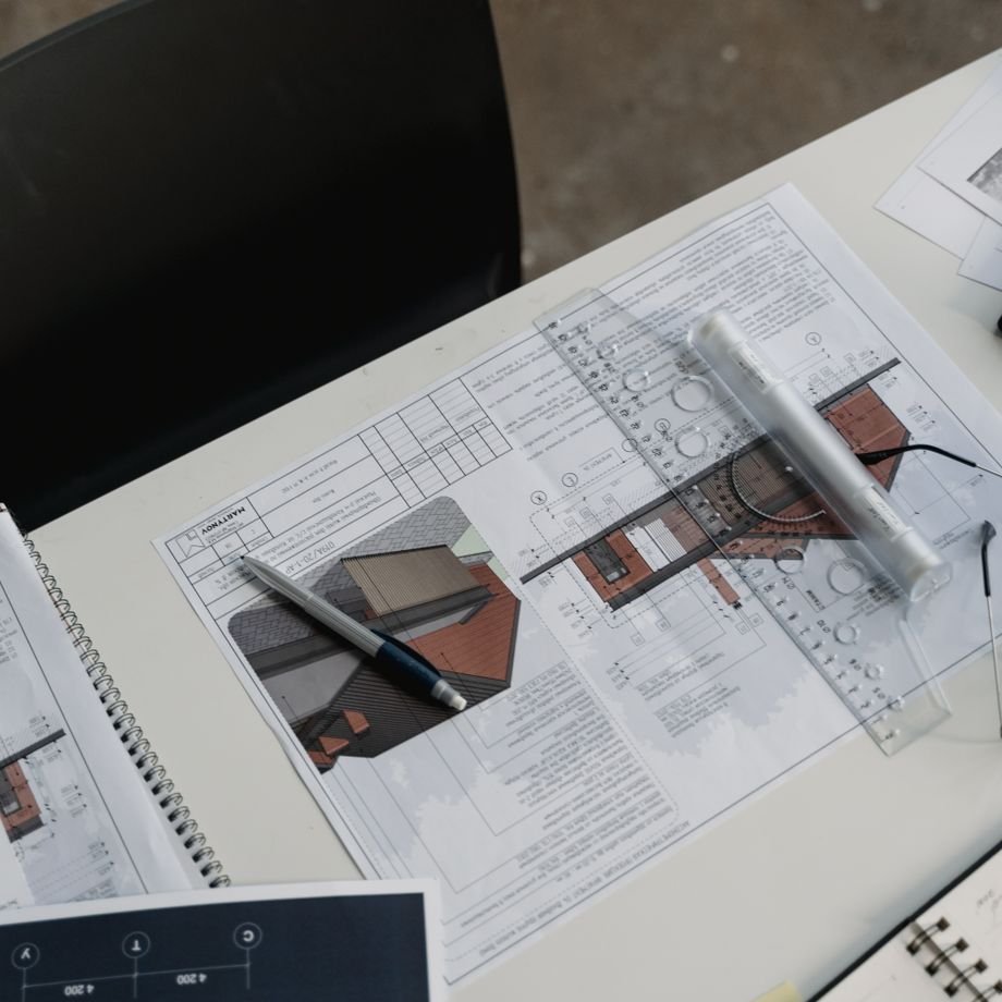 Illustrative licensed photograph: Blueprints and drafting tools