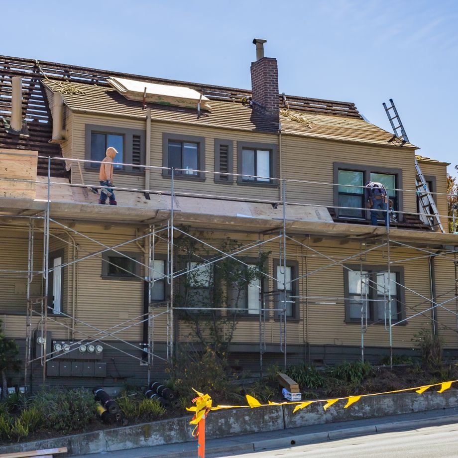 Illustrative licensed photograph: Roofing works and scaffolding on detached house