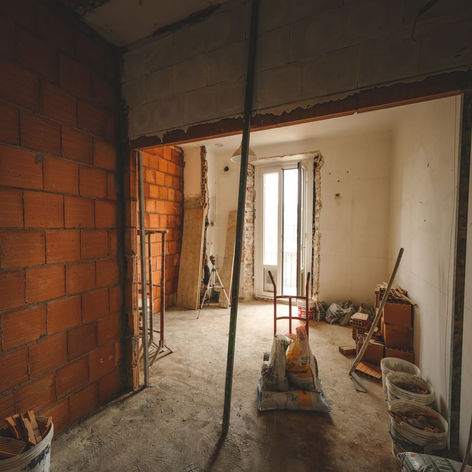 Illustrative licensed photograph: Residential renovation with exposed brick and construction debris