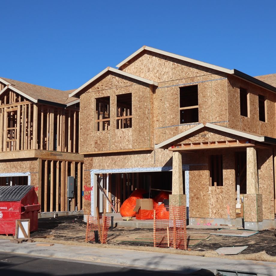 Illustrative licensed photograph: New houses under construction in residential subdivision