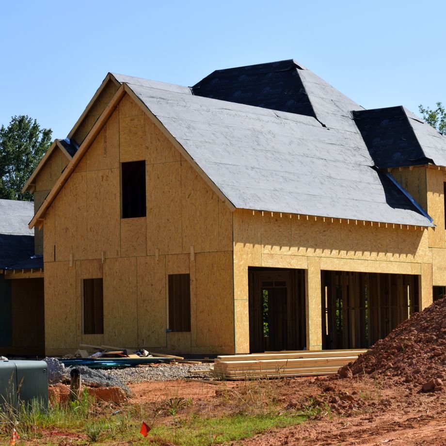 Illustrative licensed photograph: Partially framed wooden suburban house