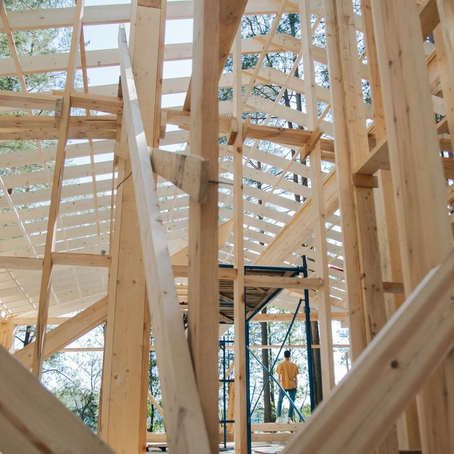 Illustrative licensed photograph: Wood house interior framing during construction